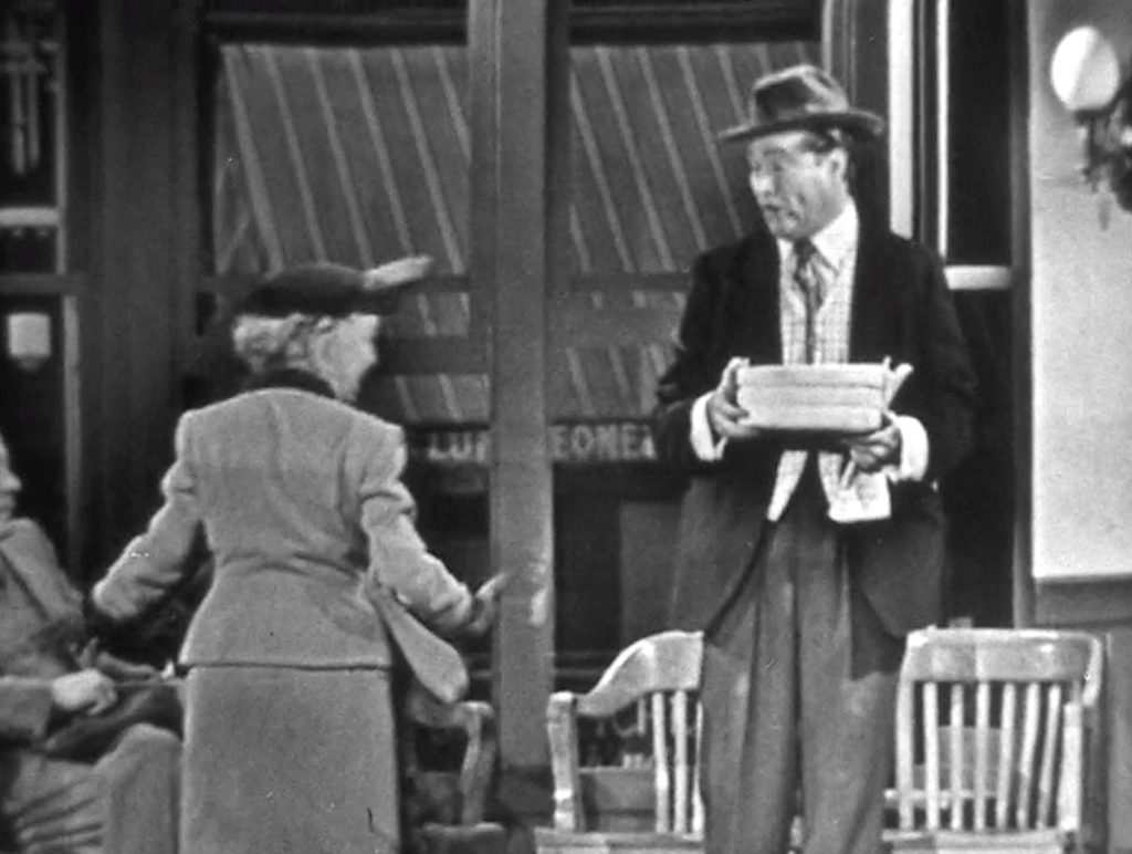 Clem helping the old lady with the (explosive) cake for her inmate son.jpg