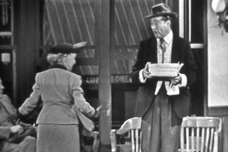 Clem helping the old lady with the (explosive) cake for her inmate son.jpg