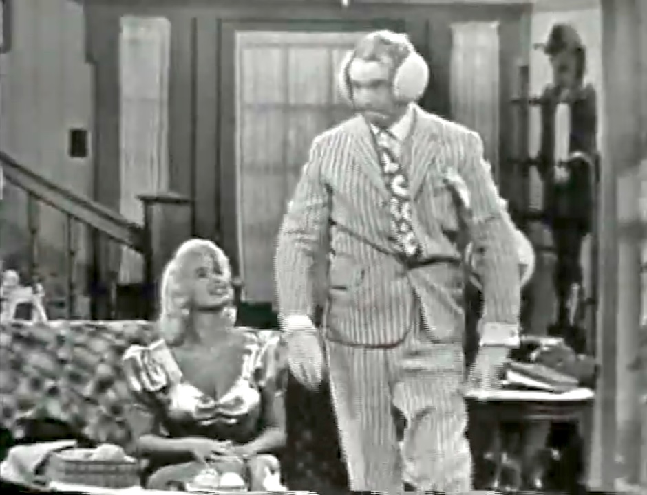 Daisy June (Jayne Mansfield) has knitted earmuffs for Clem Kadiddlehopper, using the mule as a model! If it fits one jackass…