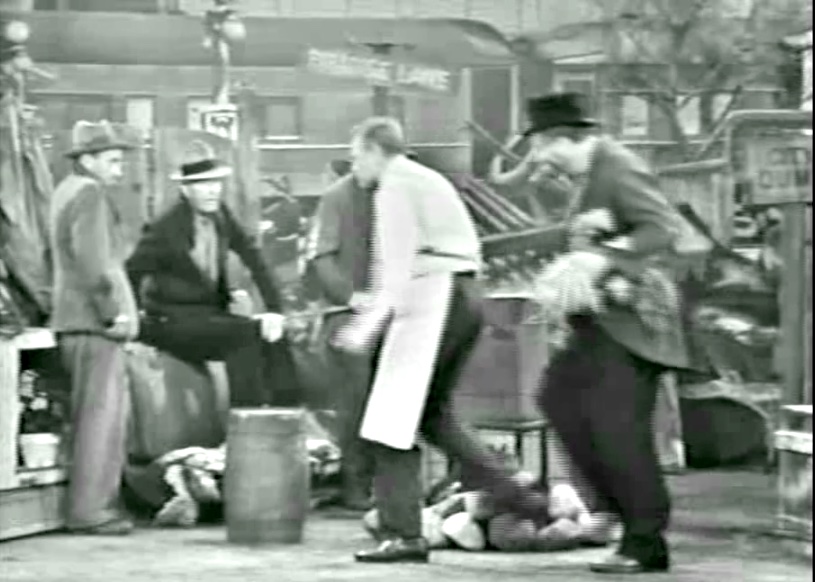 Grocer trailing Freddie the Freeloader for stealing the ingredients for the mulligan stew