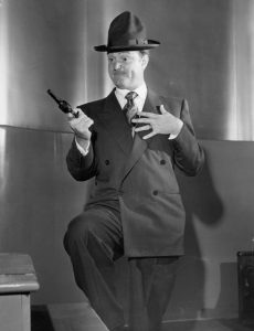 Red Skelton holding a gun on the studio audience during his monologue