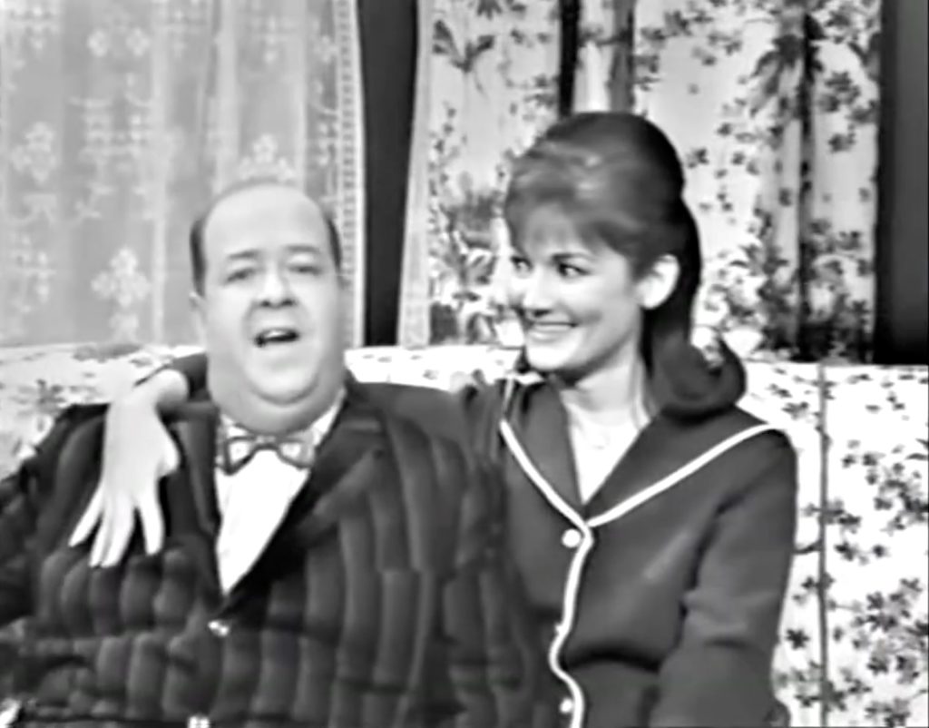 Stubby Kaye singing "The Music Goes Round and Round"