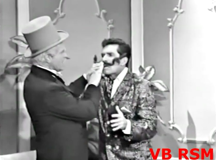 San Fernando Red tries attaching the bogus mustache