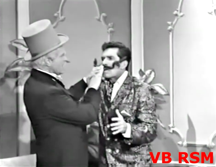 San Fernando Red tries attaching the bogus mustache