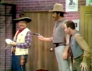 The bank robber threatens to kill Sheriff Deadeye in "Sheriffs are Bought Not Made"