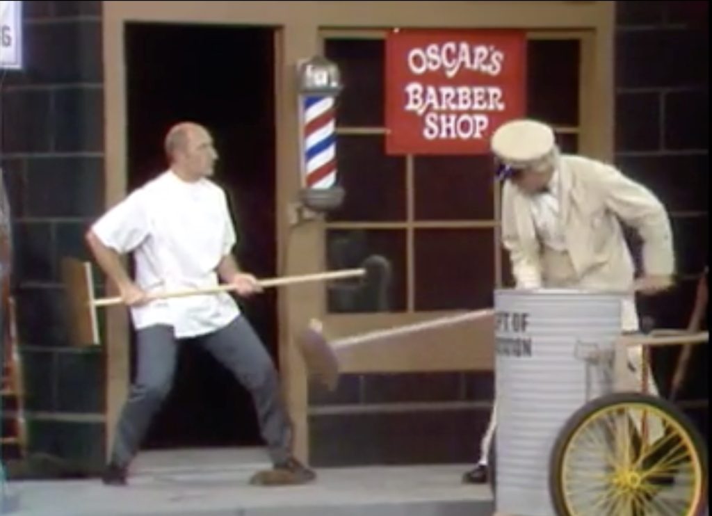 Pops fighting with the barber in "He Who Steals My Dump Steals Trash"