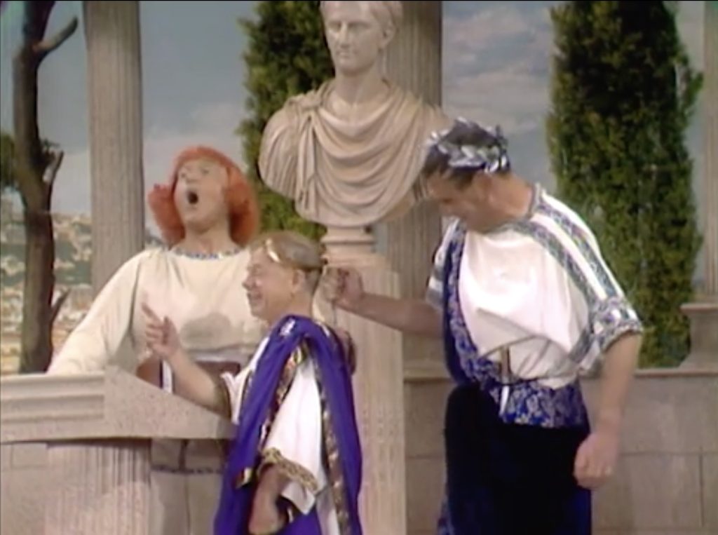 Brutus finally succeeds in stabbing Julius Caesar while Obnoxious watches