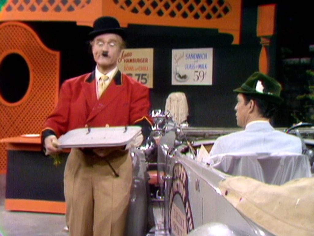 Car hop Red Skelton, impersonating Charlie Chaplin, trying to impress the talent agent.