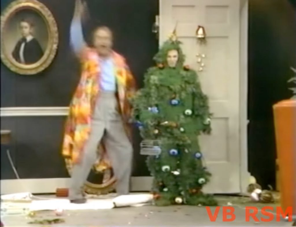 Red Skelton triumphant with his Christmas tree wife