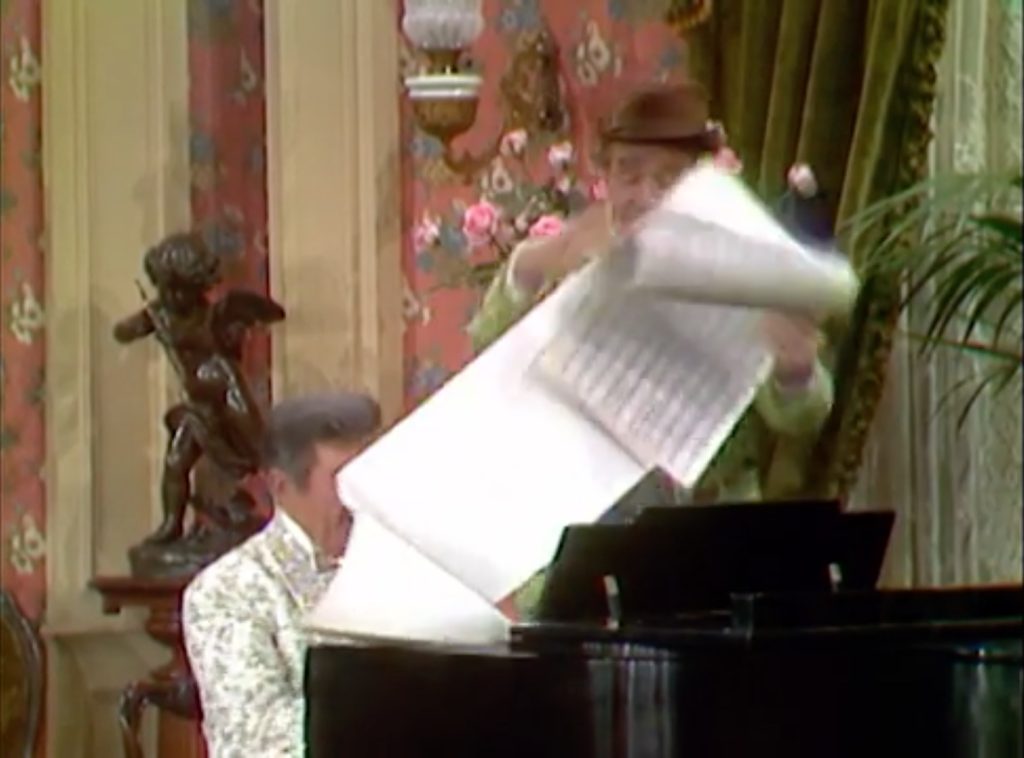 Clem Kadiddlehopper "helps" Liberace by turning the music pages