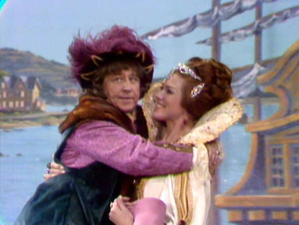 Queen Isabella (Francine York) carrying Christopher Columbus (George Gobel).