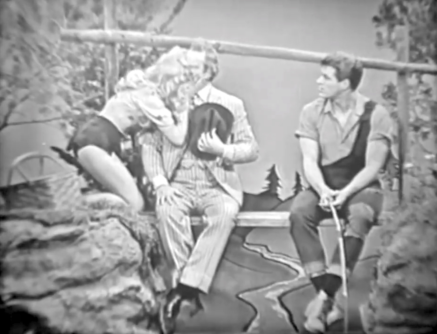 Daisy Mae kisses Clem while Li'l Abner watches