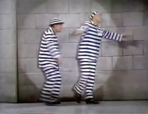 Bolivar Shagnasty (Red Skelton) and Butch (Cesar Romero) dancing in the prison spotlight