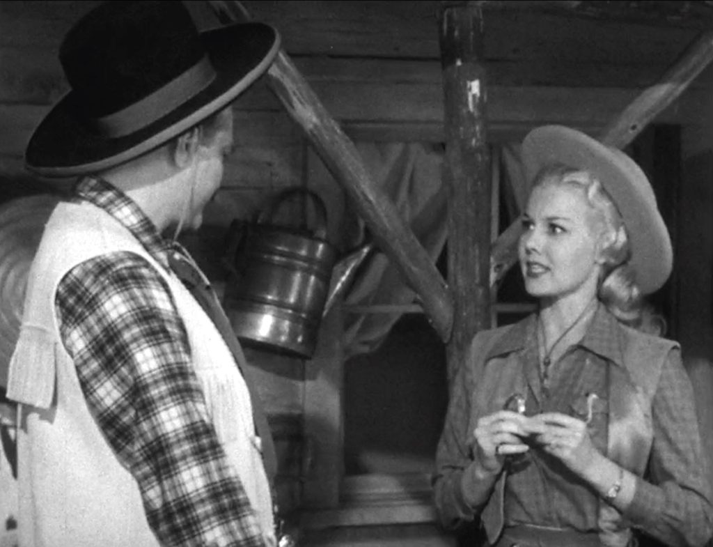 Deadeye about to learn how to roll a cigarette from cowgirl Lucy Knoch in "Quiz Show Winner"