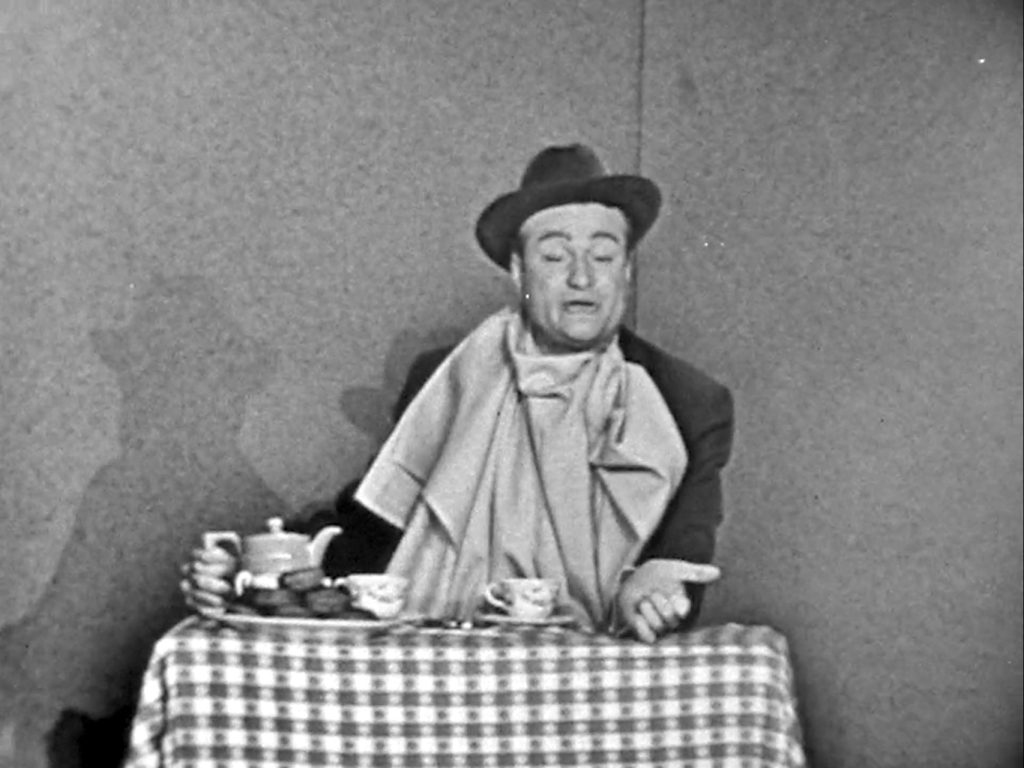 Red Skelton doing his famous vaudeville routine, dunking donuts