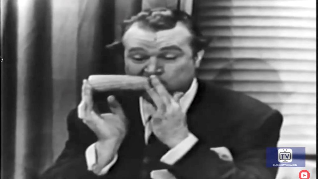 Red Skelton, as Iowa Pete, demonstrates how to eat corn like a typist