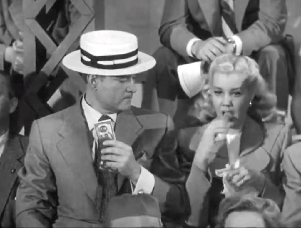 Everyone takes a bite of Red Skelton's hot dog - except Red! As Lucille Knoch demonstrates