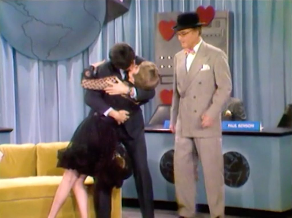 Extended kiss between Clara and the contestant while George Appleby watches