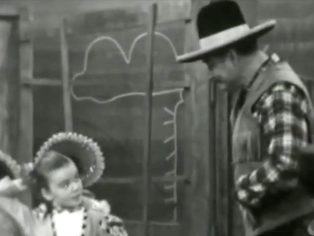 Flirting to keep Deadeye in the saloon until Kit Carson returns