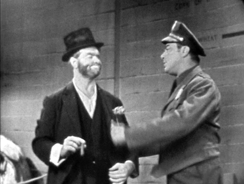 Police officer gives Freddie the Freeloader five minutes to clear out or else!
