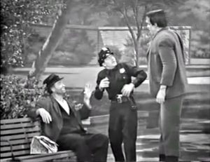 Freddie the Freeloader takes advantage of his new friend, Herman Munster, to frighten a cop in the park