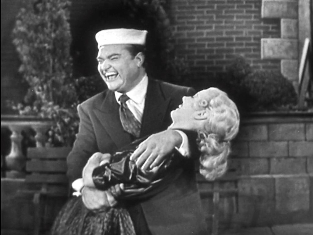 Give us a kiss, baby! Red Skelton's ad libs keep breaking Lucille Knoch up!