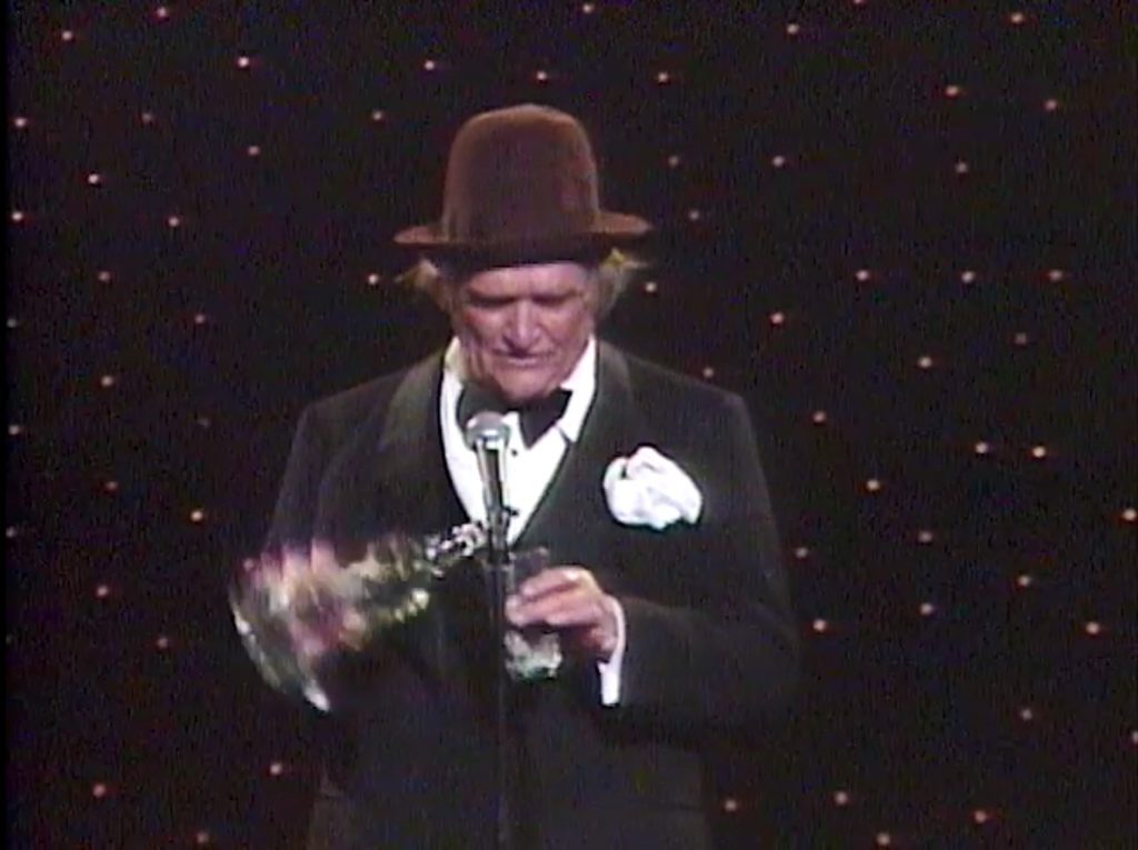 Elderly Red Skelton doing his Guzzler's Gin routine in "Royal Command Performance"