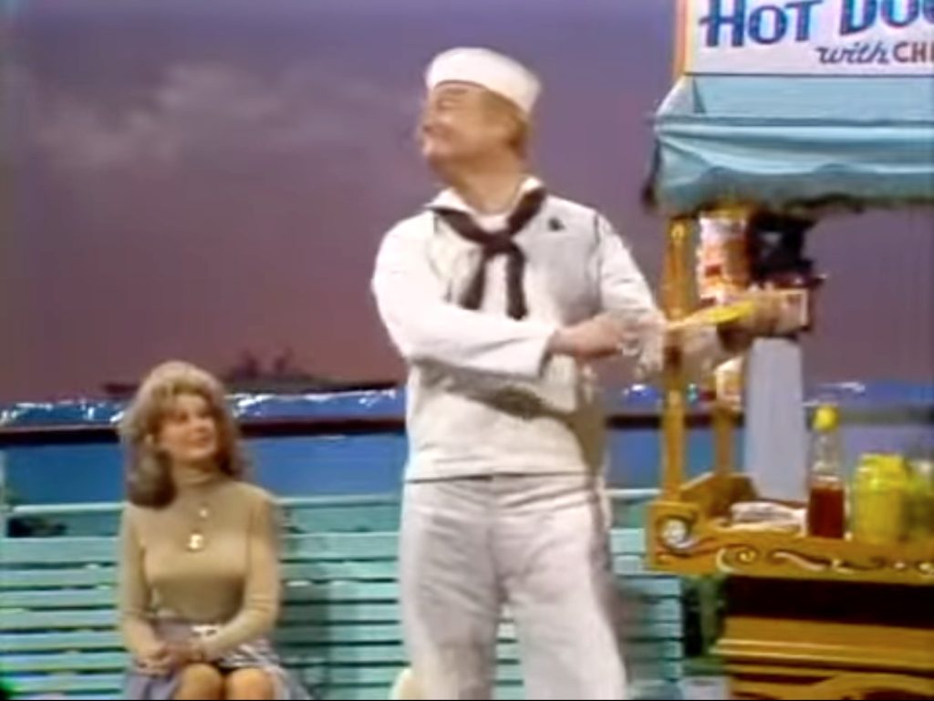 Hot dog routine, where sailor Red Skelton puts the mustard on his hand as Chanin Hale watches