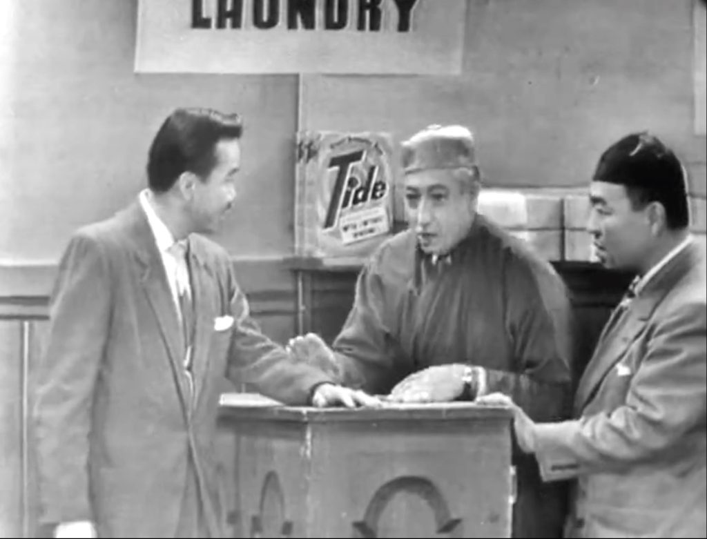 Kam Tong, "mayor of San Francisco" picking up his laundry from Benny Rubin's Chinese Laundry - with a box of Tide prominently displayed