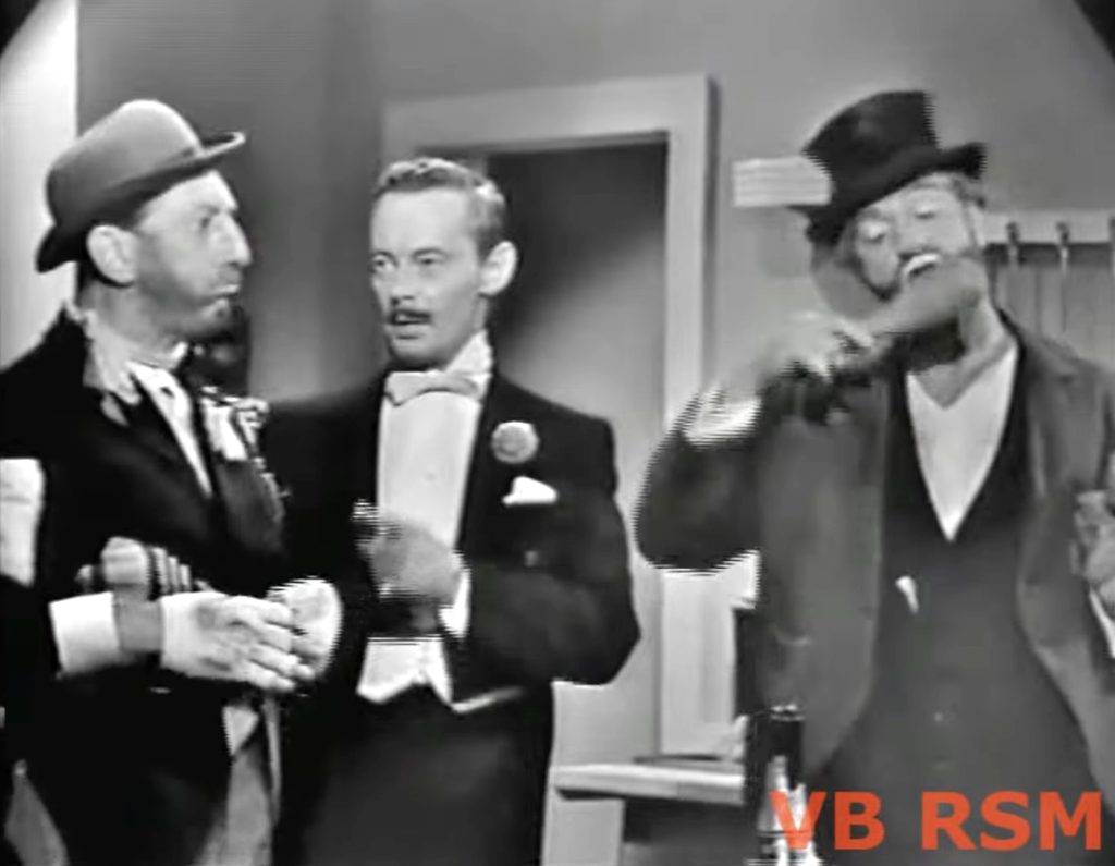 Mayor Threadbare (Ray Bolger), his butler (Gilchrist Stuart) and Freddie the Freeloader in his kitchen