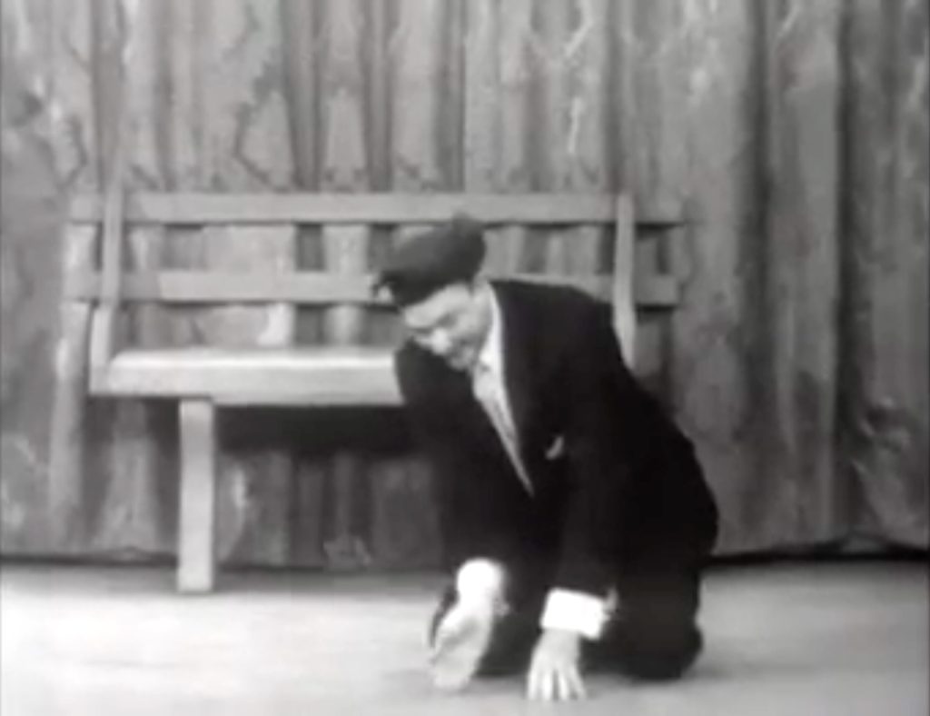 Red Skelton pantomiming a little boy, planting a seed