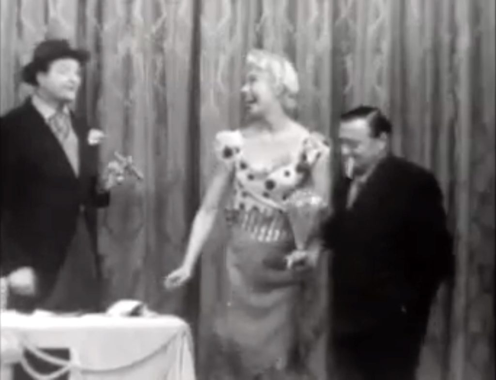 … and a young boy (Peter Lorre) to help her carry it!
