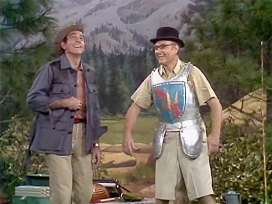 Henry (Mike Connors) laughs as George Applebby's wearing his suit of armor