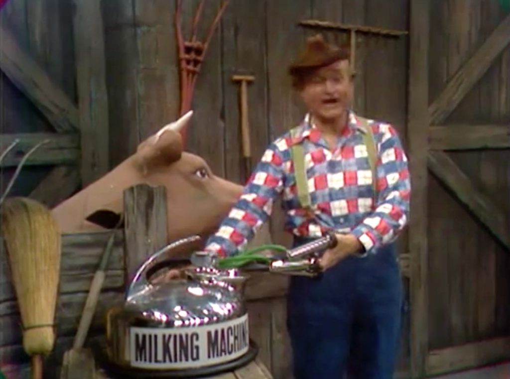 Clem Kadiddlehopper trying to milk the cow in "The Spy with the Leaky Mouth"