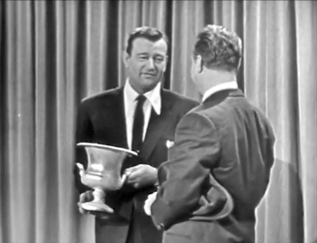 Red Skelton presents John Wayne with Modern Screen Magazine's award as the most popular actor of 1953