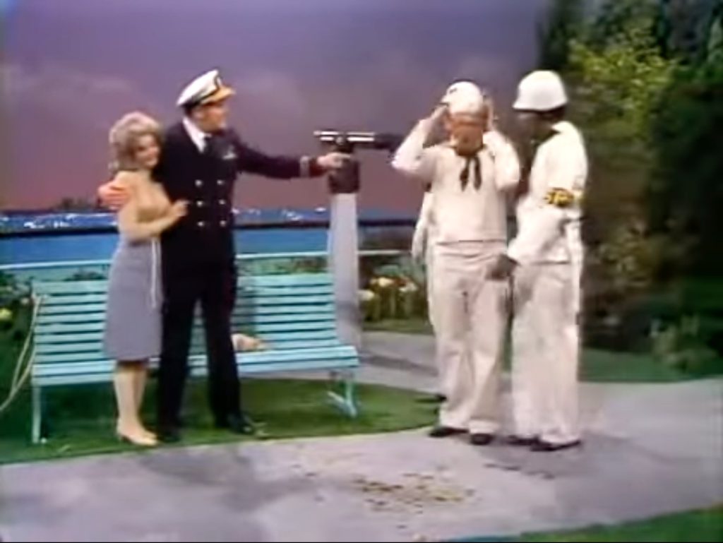 Chanin Hale and Admiral Ray Kellogg watching as Sailor Red Skelton's taken away by the military police!