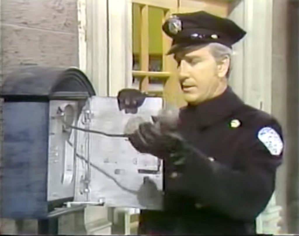 Officer Ryan makes a mysterious call in "The Red Skelton Christmas Show 1970"