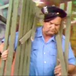 Police officer (Jackie Coogan) unintentionally hit by Freddie's park bench in "Hippie Days are Here Again"