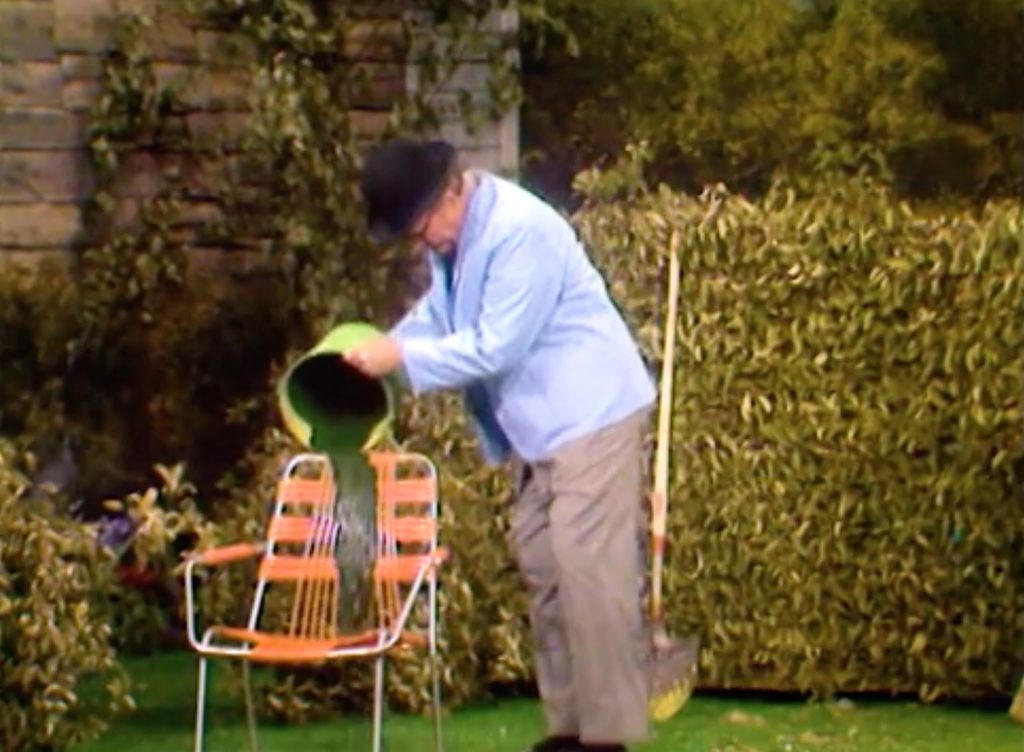 George Appleby pouring paint over the chair