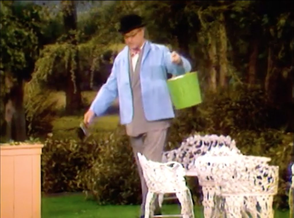 George Appleby obediently puts on to coats to paint the chair!