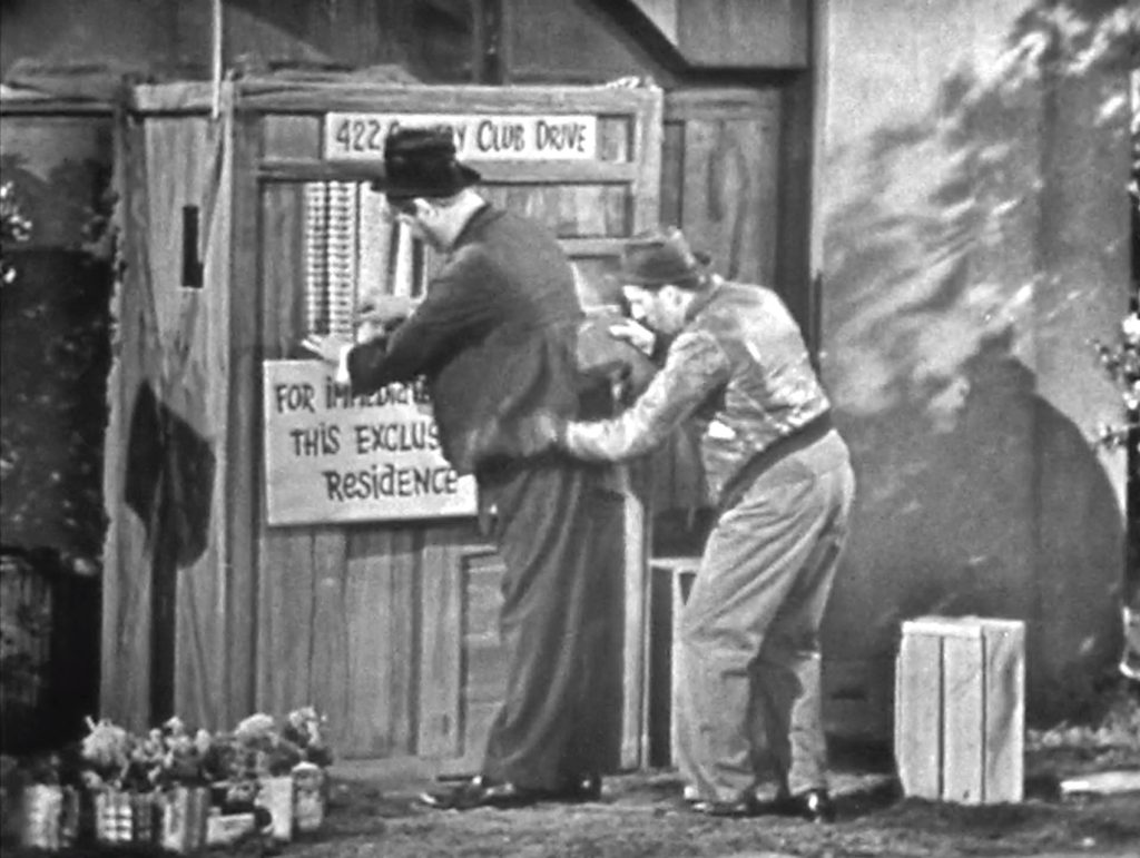 Thief putting stolen radio in Freddie's pocket