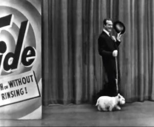 Red Skelton walking a white dog in "The Railroad Station"