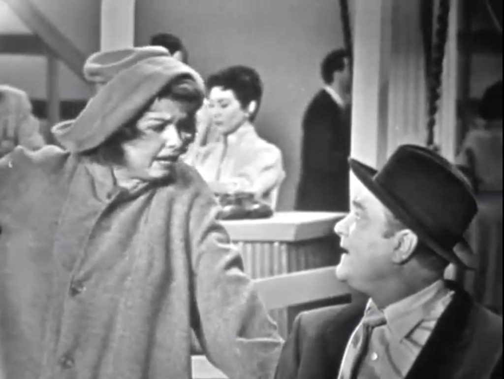 Sadie Murphy (Mary McCarty) does her sales pitch to the "restrained" Red Skelton in Love Thy Neighbor