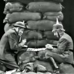 Soldiers Red Skelton and Harpo Marx, on opposite sides, play checkers