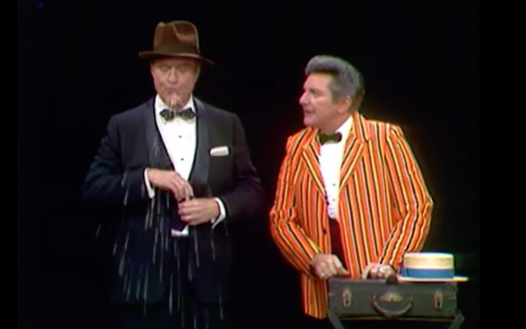 In the One Minute Drama, the pitchman (Liberace) tries to sell Red Skelton a potion so he'll never have to brush his teeth again …