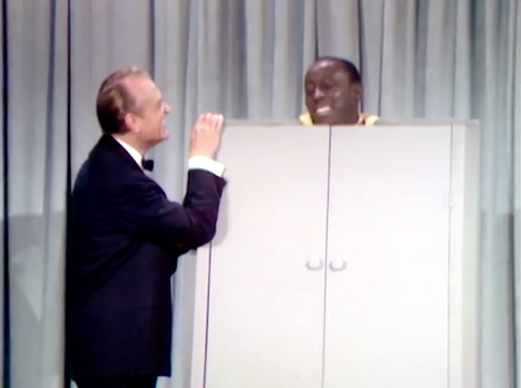 Red Skelton helping Godfrey Cambridge lose weight in a steam cabinet