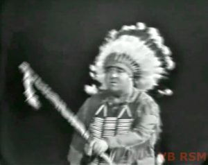 Stubby Kaye as an Indian Chief, about to meet Pilgrim Red in "Ten Little Fingers and Twelve Little Toes"