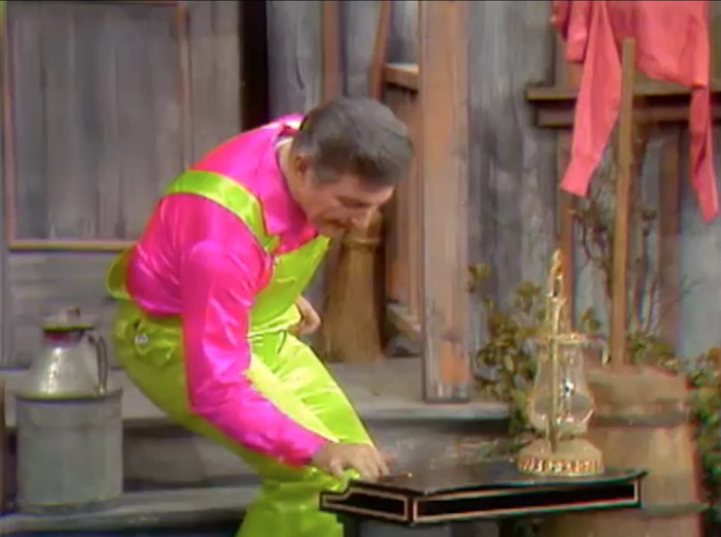 Liberace playing a toy piano on the Kadiddlehopper farm - with a lamp instead of a candelabra!