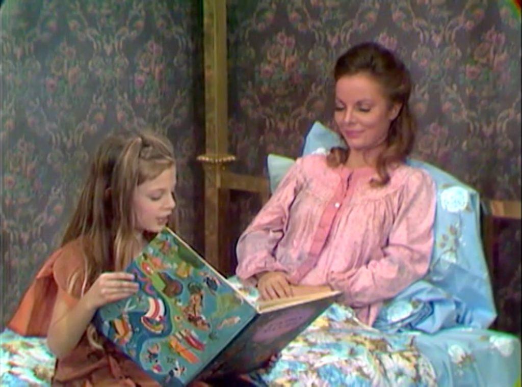 The Christmas urchin reads a book to her mother, Kathleen