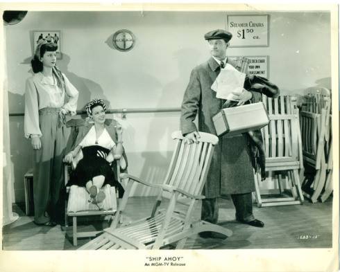 Virginia O’Brien, Eleanor Powell, and Red Skelton trying to relax on board ship in deck chairs – if Red can win his battle with the chair in Ship Ahoy